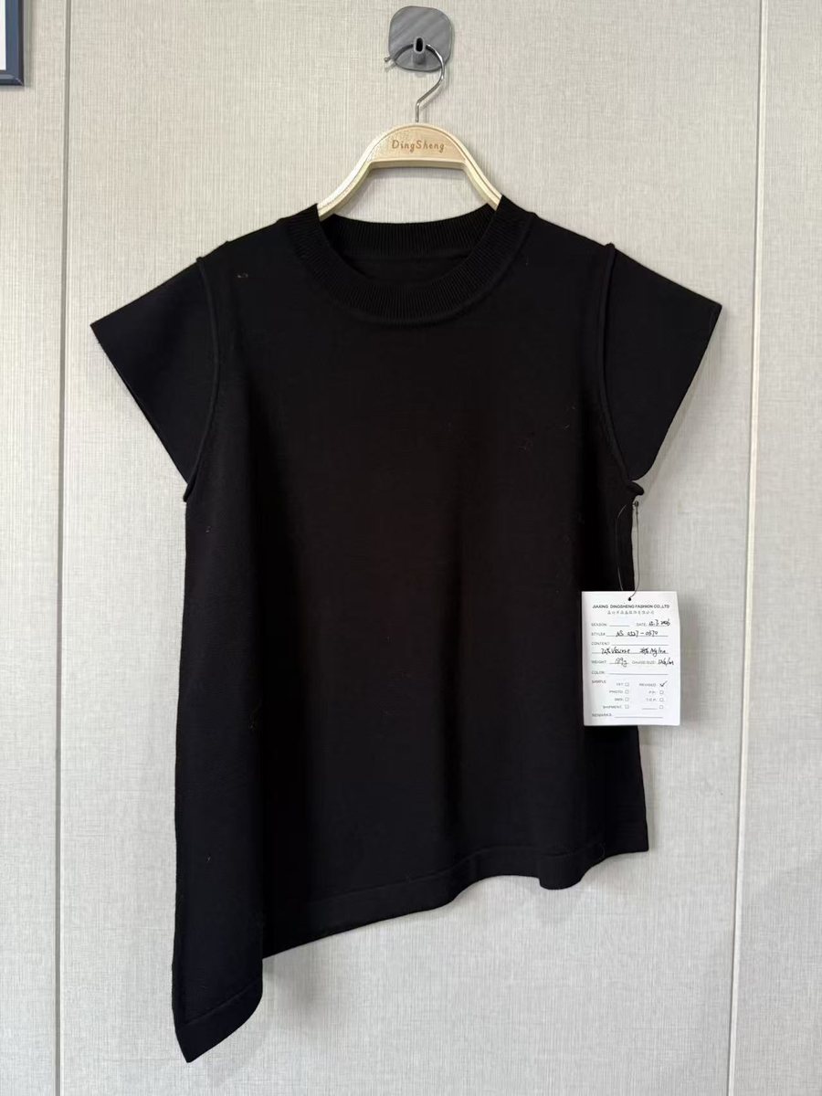 Black asymmetric short-sleeve knit top, style NS 0527-0370, from the Knitwear World sample collection