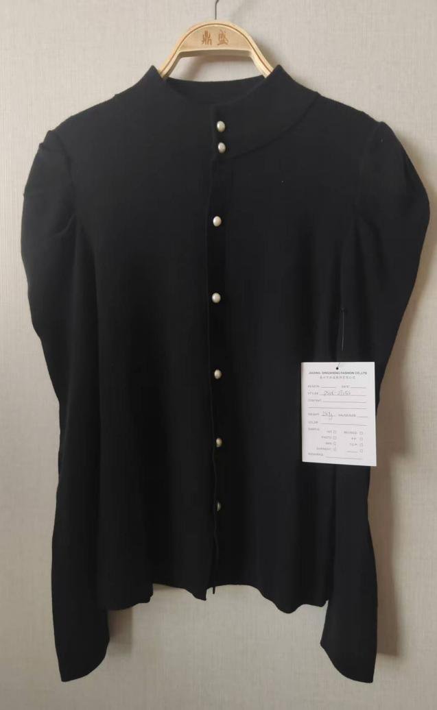 Black button-front knit top with puff shoulders, style DS26-07053, from the Knitwear World sample collection