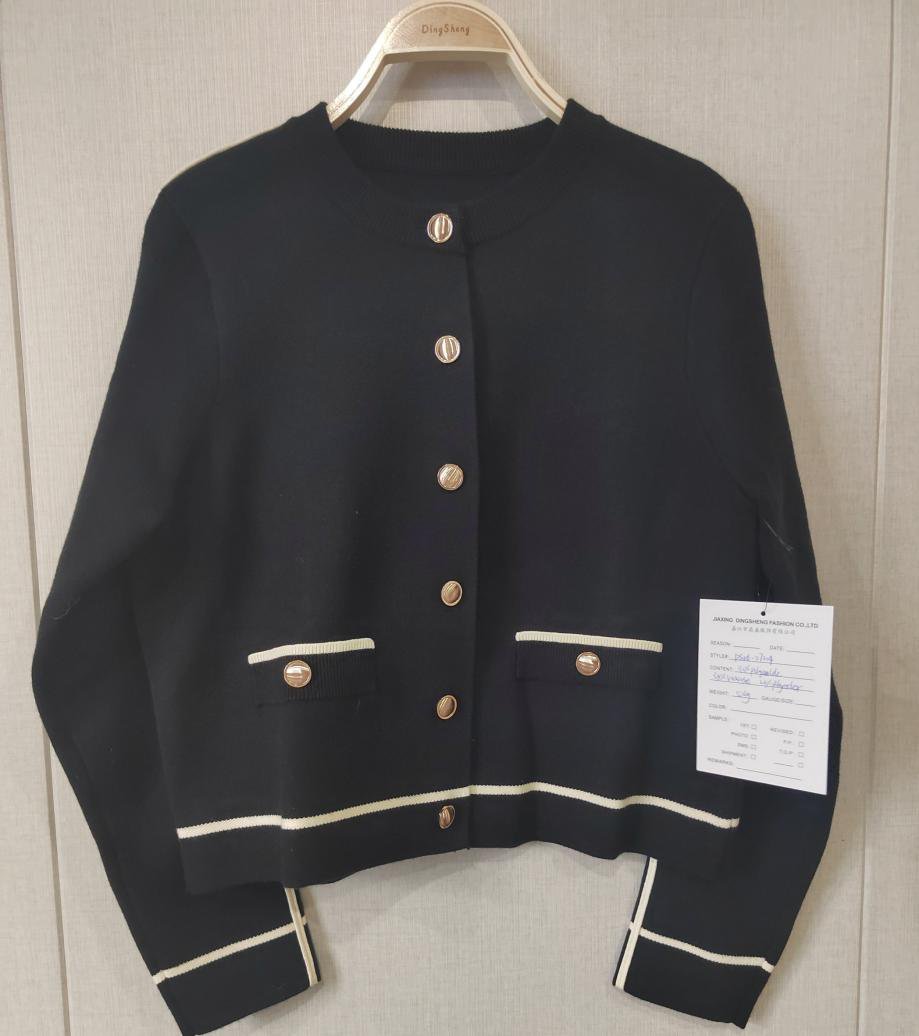 Black cardigan with gold buttons and ivory trim, style DS26-07004, from the Knitwear World sample collection