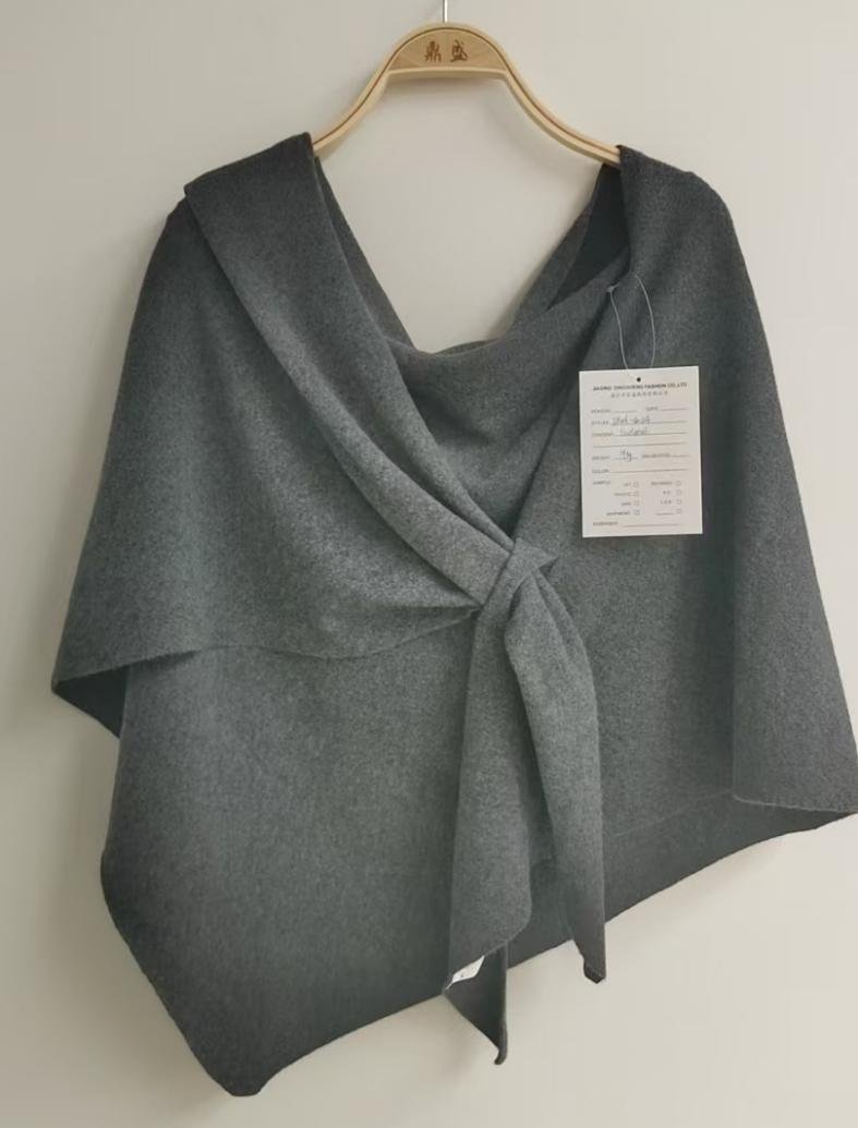 Grey asymmetric knit wrap with tie, style DS26-08024, from the Knitwear World sample collection