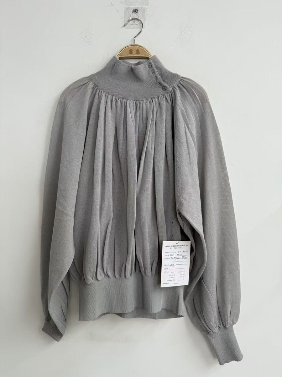 Grey pleated mock-neck knit top with puff sleeves, style DS27-K1047, from the Knitwear World sample collection