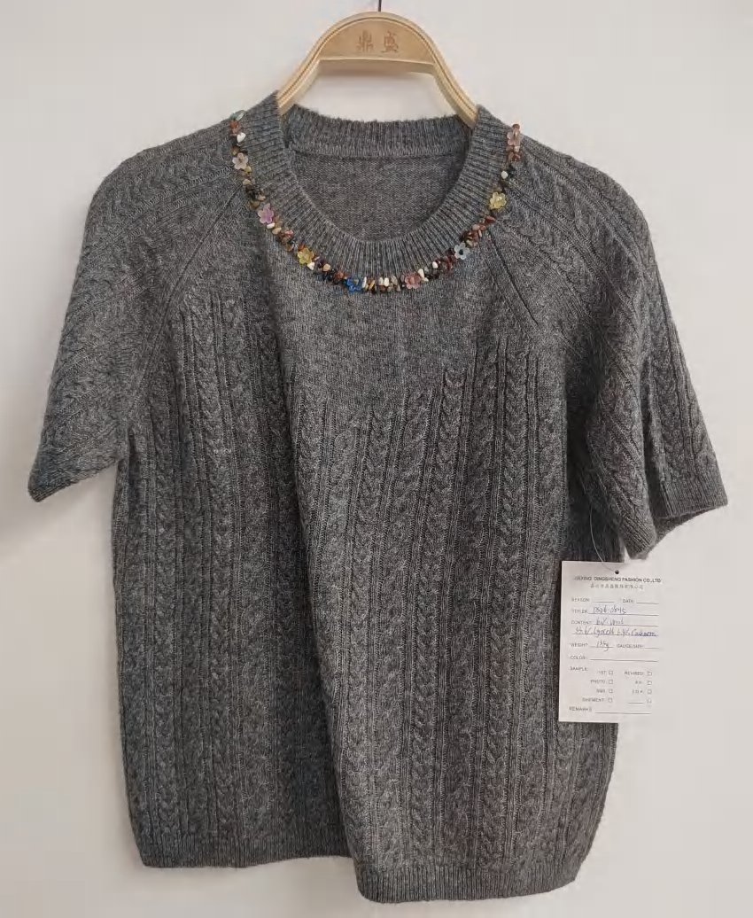 Grey short-sleeve cable top with embellished neckline, style DS26-08015, from the Knitwear World sample collection