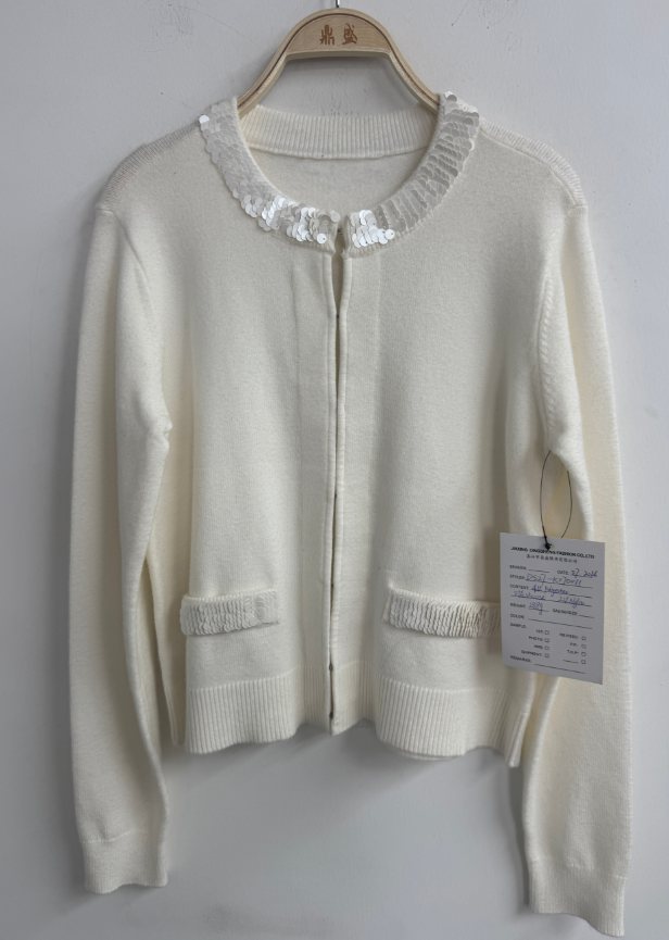 Ivory cardigan with ruffled collar and pockets, style DS27-K070011, from the Knitwear World sample collection