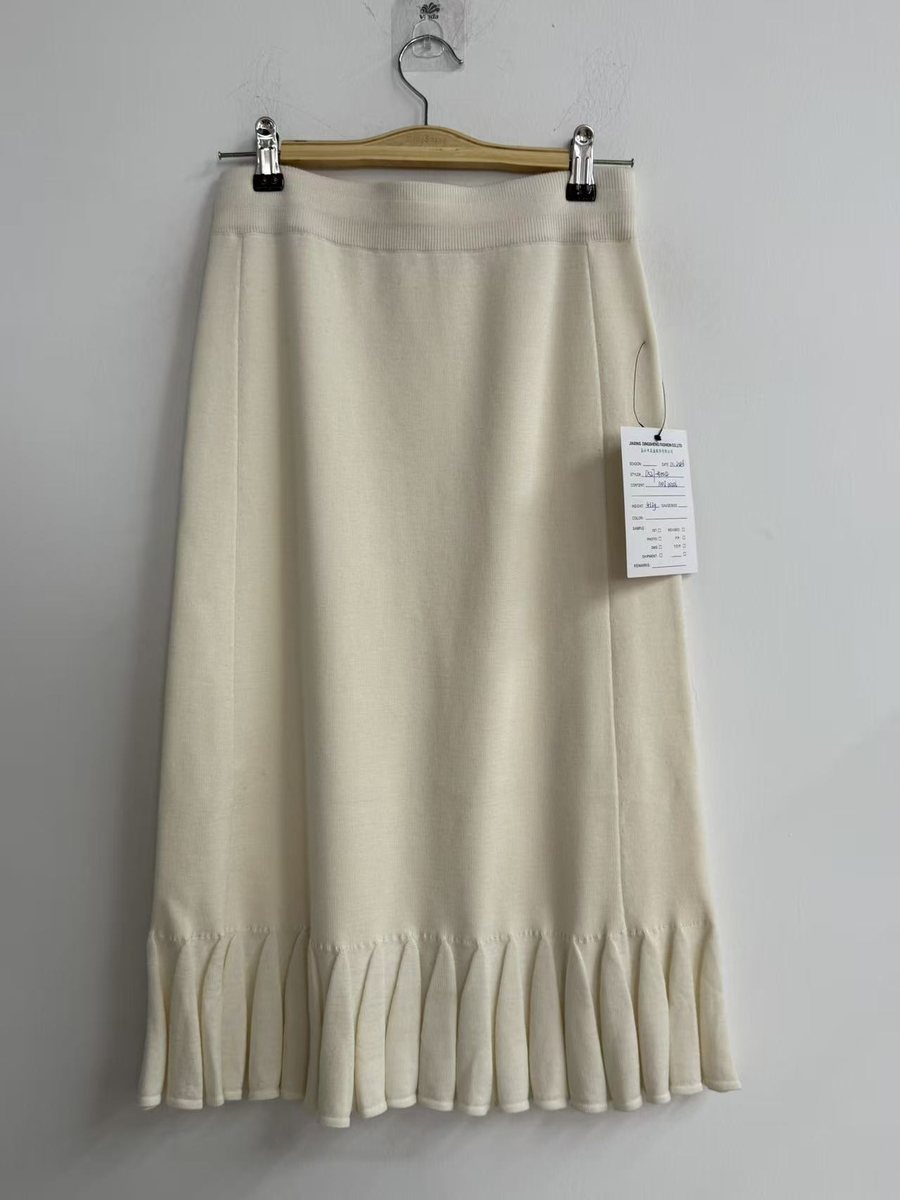 Ivory knit midi skirt with ruffle hem, style DS27-K1004, from the Knitwear World sample collection