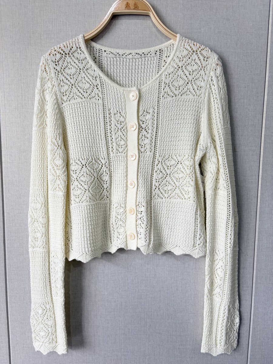 Ivory pointelle cardigan with scalloped hem, style DS27-K04047, from the Knitwear World sample collection