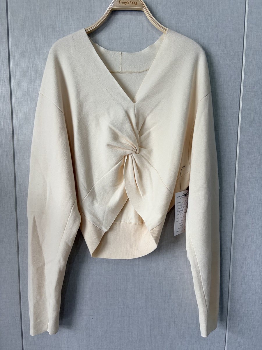 Ivory twist-front pullover with V-back, style DS27-K070012, from the Knitwear World sample collection