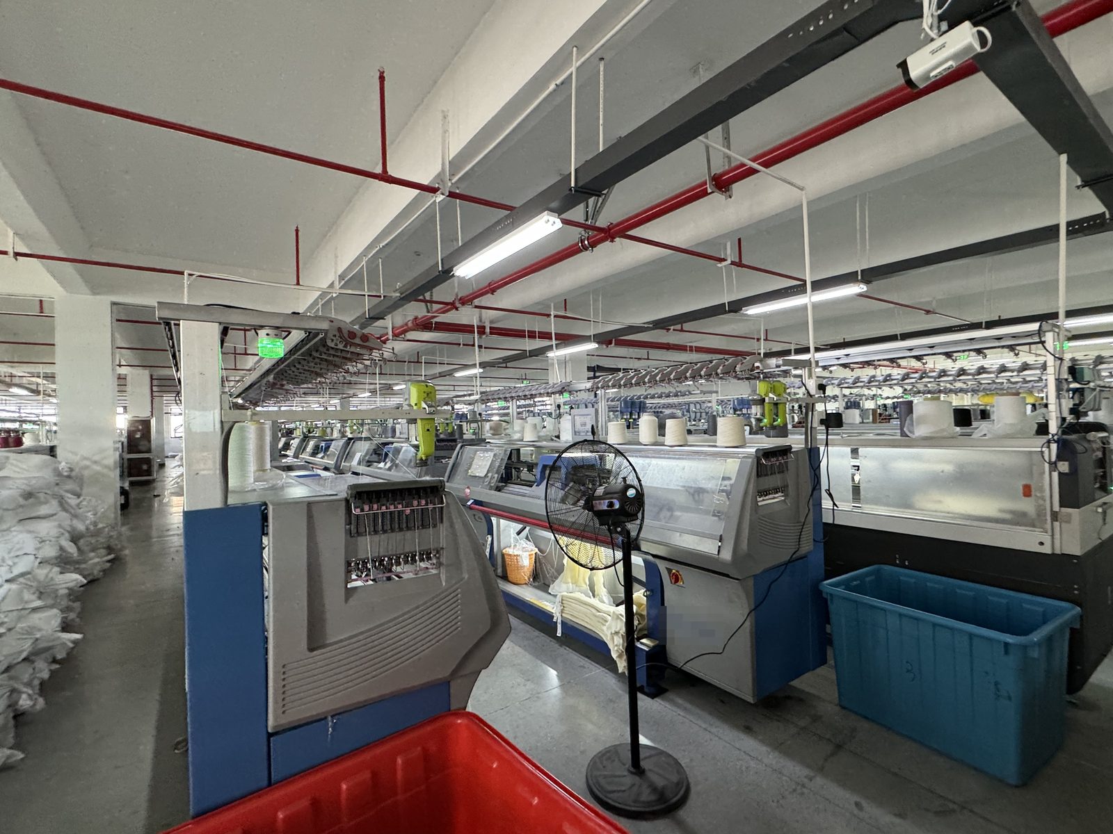 Knitting floor with computerized flat knitting machines at Knitwear World, Jiaxing