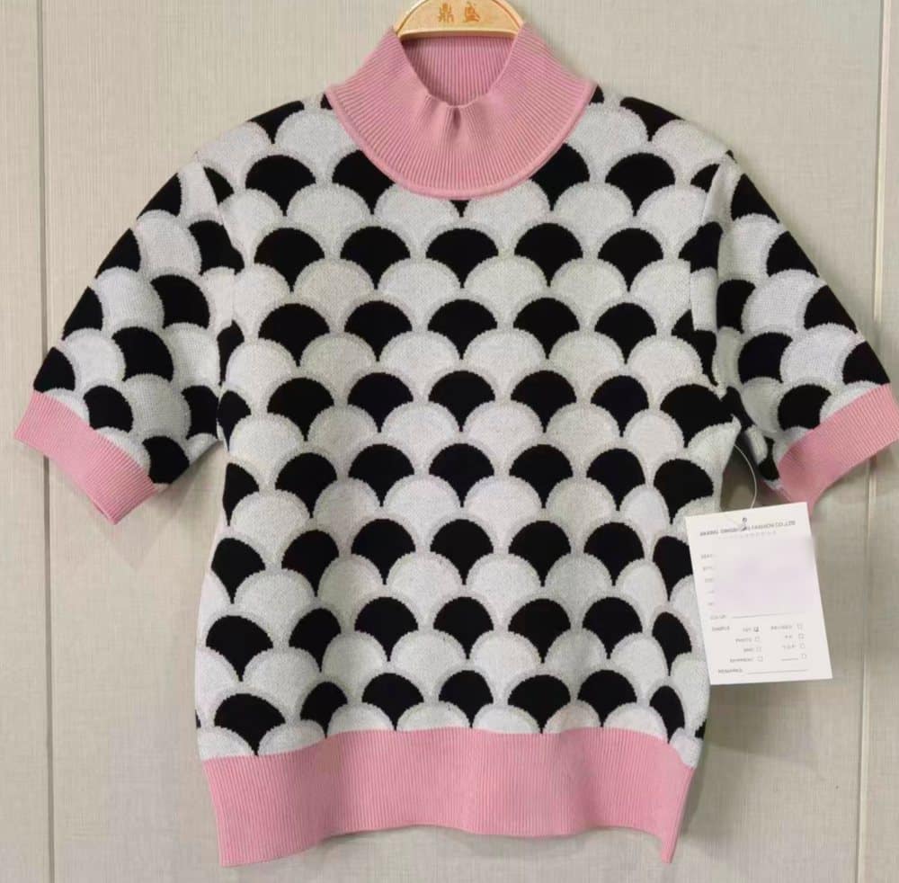 Knitwear World first sample: scallop jacquard short-sleeve knitted top with pink mock neck and rib trims