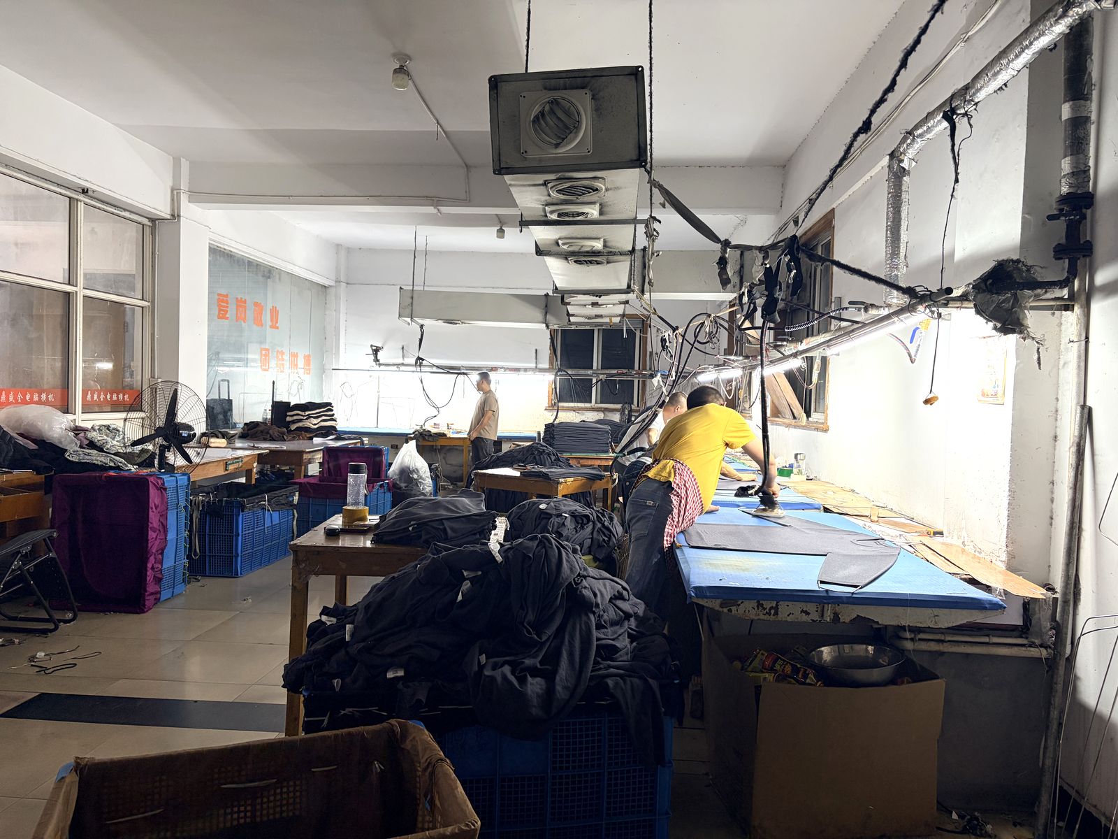 Steam pressing knitted garments to size and shape at Knitwear World, Jiaxing