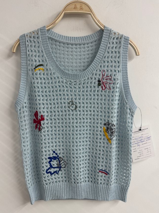 Light blue open-knit vest with embroidered motifs, style DS27-K06040, from the Knitwear World sample collection