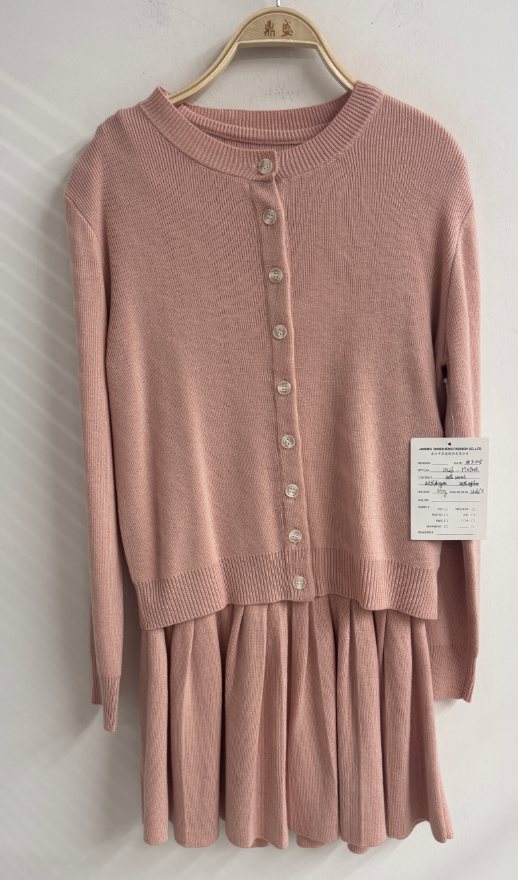 Pink cardigan and pleated knit skirt set, style DS26-TT09013, from the Knitwear World sample collection