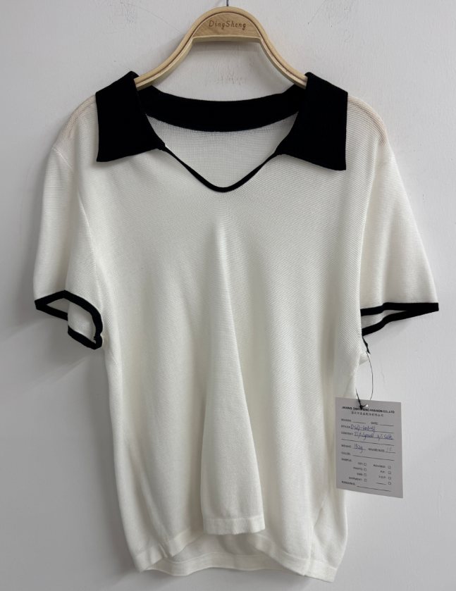 White knit top with black contrast collar, style DS27-K06031, from the Knitwear World sample collection